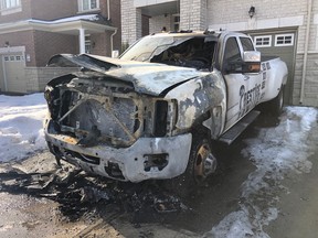 A burned-out tow truck in front of a home on Collin Ct. in Richmond Hill, one of several across Toronto and York Region that police believe are linked