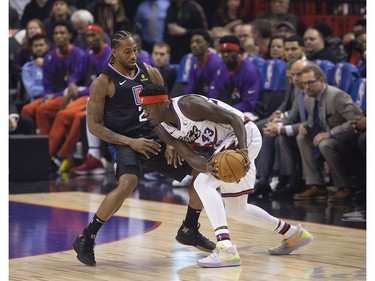 Former Raptors MVP Kawhi Leonard accepts his NBA Championship ring from former team-mate Kyle Lowry before the Raptors / Clippers game in Toronto, Ont. on Wednesday December 11, 2019.