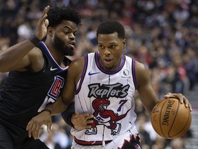 Raptors’ Kyle Lowry (right) drives on the Clippers on Wednesday night. Lowry has been in a shooting slump since he returned from injury five games ago.  Stan Behal/Toronto Sun