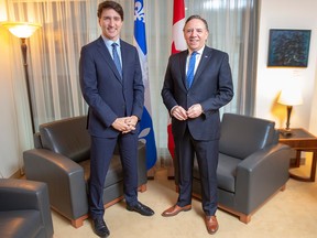 Prime Minister Justin Trudeau and Quebec Premier Francois Legault pose for photos before their first meeting since the election, in Montreal, Friday, Dec. 13, 2019.