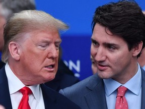 TOPSHOT - US President Donald Trump (L) talks with Canada's Prime Minister Justin Trudeau during the plenary session of the NATO summit at the Grove hotel in Watford, northeast of London on December 4, 2019. (Photo by Nicholas Kamm / AFP) (Photo by NICHOLAS KAMM/AFP via Getty Images)