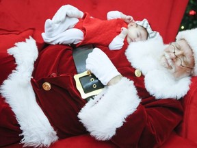 Veteran Santa Bob King at Hillcrest Mall with baby Leah Mohyeddin on Thursday December 5, 2019. Veronica Henri/Toronto Sun/Postmedia Network