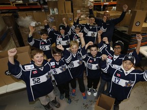 Toronto Paramedic Rahul Singh of GlobalMedic got an assist from members of the Markham Waxers Hockey Team and helping to pack Family Emergency Kits to support families affected by disaster. Each kit will provide a water purification solution, hygiene items and solar lights on Saturday December 14, 2019. Jack Boland/Toronto Sun/Postmedia Network