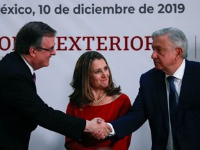 Canadian Deputy Prime Minister Chrystia Freeland looks on while Mexico's President Andres Manuel Lopez Obrador shakes hands with Mexico's Foreign Minister Marcelo Ebrard, during a meeting at the Presidential Palace, in Mexico City, Mexico December 10, 2019.