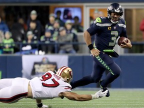 Defensive end Nick Bosa of the San Francisco 49ers tries to take down quarterback Russell Wilson of the Seattle Seahawks. (GETTY IMAGE)