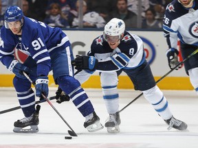 Maple Leafs' John Tavares battles against Winnipeg Jets' Andrew Copp during Wednesday's game. (GETTY IMAGES)