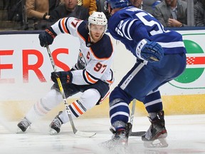 Connor McDavid of the Edmonton Oilers slips away from Martin Marincin of the Toronto Maple Leafs during an NHL game at Scotiabank Arena on January 6, 2020 in Toronto, Ontario, Canada.