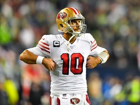 Jimmy Garoppolo of the San Francisco 49ers walks back to the huddle after a timeout during the second quarter of the game against the Seattle Seahawks at CenturyLink Field on December 29, 2019 in Seattle, Washington.