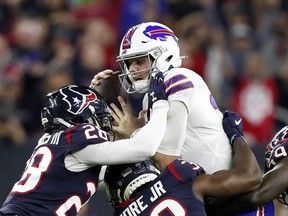 Quarterback Josh Allen of the Buffalo Bills is tackled by the defense of the Houston Texans during the AFC Wild Card Playoff game at NRG Stadium on January 04, 2020 in Houston, Texas.