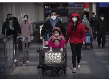 BEIJING, CHINA - JANUARY 30: Passengers wear protective masks as they walk he their luggagein the arrivals area at Beijing Capital Airport on January 30, 2020 in Beijing, China. The number of cases of a deadly new coronavirus rose to over 7000 in mainland China Thursday as the country continued to lock down the city of Wuhan in an effort to contain the spread of the pneumonia-like disease which medicals experts have confirmed can be passed from human to human. In an unprecedented move, Chinese authorities put travel restrictions on the city which is the epicentre of the virus and neighbouring municipalities affecting tens of millions of people. The number of those who have died from the virus in China climbed to over 170 on Thursday, mostly in Hubei province, and cases have been reported in other countries including the United States, Canada, Australia, Japan, South Korea, and France. The World Health Organization  has warned all governments to be on alert, and its emergency committee is to meet later on Thursday to decide whether to declare a global health emergency.