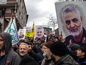 People hold posters showing the portrait of Iranian Revolutionary Guard Major General Qassem Soleimani and chant slogans during a protest outside the U.S. Consulate on Jan. 5, 2020 in Istanbul, Turkey. (Chris McGrath/Getty Images)