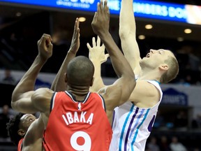 Hornets forward PJ Washington (left) fouls Raptors centre Serge Ibaka during second-quarter action at the Spectrum Center in Charlotte last night.  Jim Dedmon/USA TODAY Sports ORG