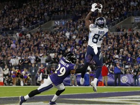 Corey Davis of the Tennessee Titans catches a touchdown pass from Derrick Henry  (not pictured) over Earl Thomas of the Baltimore Ravens in the third quarter of the AFC Divisional Playoff game at M&T Bank Stadium on January 11, 2020 in Baltimore, Maryland.