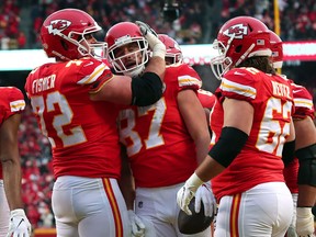 Kansas City Chiefs Travis Kelce, centre, is congratulated by his teammates Eric Fisher, left, and Austin Reiter after his third touchdown reception of the second quarter against the Houston Texans in the AFC Divisional playoff game at Arrowhead Stadium on Jan. 12, 2020 in Kansas City, Miss. (Tom Pennington/Getty Images)