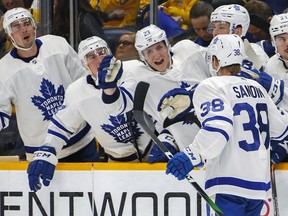 Travis Dermott of the Toronto Maple Leafs congratulates teammate Rasmus Sandin on scoring a goal against the Nashville Predators during the second period at Bridgestone Arena on January 27, 2020 in Nashville, Tennessee.