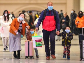 Commuters wearing face masks walk in Hankou railway station in Wuhan, in China's central Hubei province on Jan. 21, 2020. (AFP via Getty Images)