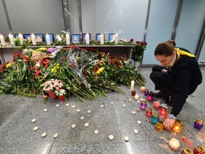 A flight staffer arranges candles at a memorial for the victims of the Ukraine International Airlines Boeing 737-800 crash in the Iranian capital Tehran, at the Boryspil airport outside Kiev on January 8, 2020. (AFP/Getty Images)
