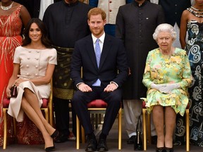 Britain's Queen Elizabeth, Prince Harry and Meghan, the Duchess of Sussex, pose for a picture at in London, Britain June 26, 2018. (Reuters)