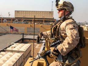 This handout image -- released courtesy of the U.S. defence department -- shows a soldier with 2nd Battalion, 7th Marines, assigned to the Special Purpose Marine Air-Ground Task Force-Crisis Response-Central Command,  reinforcing the Baghdad Embassy compound in Iraq on January 3, 2020