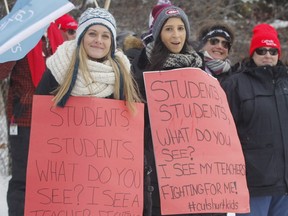Teachers who are members with of the Ontario English Catholic Teachers Association conducted a one-day strike Tuesday in Toronto and across the rest of the province, including these educators  outside Archbishop O'Sullivan Catholic School in Kingston. (Postmedia Network)
