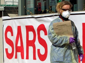 A nurse wearing protective gear walks outside a Severe Acute Respiratory Syndrome Clinic (SARS) in suburban Toronto, April 24, 2003. REUTERS