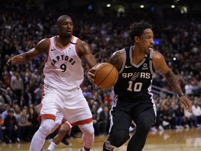 San Antonio Spurs guard DeMar DeRozan controls the ball as Raptors forward Serge Ibaka closes in during Sunday's game. (USA TODAY SPORTS)