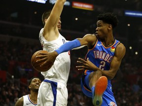 Oklahoma City Thunder point guard  Shai Gilgeous-Alexander passes around Los Angeles Clippers' Ivica Zubac. (GETTY IMAGES)