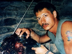 Master Cpl. Clayton Matchee holds a semi-automatic gun to the head of 16-year-old Shidane Abukar Arone as he was tied up and bleeding inside a bunker on March 16, 1993 inside the Canadian Airborne Regiment (CAR) base in Belet Huen, Somalia. Arone later died from his injuries. 
(Somalia Commission of Inquiry Released Photo)