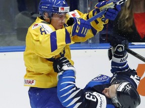 Sweden's Rasmus Sandin, left, checks Finland's Ville Petman during the U20 Ice Hockey Worlds bronze medal match between Finland and Sweden in Ostrava, Czech Republic. (AP Photo/Petr David Josek)