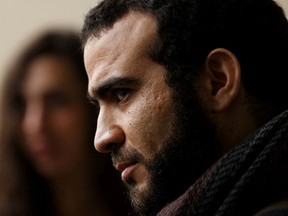 Omar Khadr (right) listens as his lawyer Nate Whitling speaks after leaving Court of Queen's Bench in Edmonton, on Monday, March 25, 2019 after a judge declared his sentence expired.