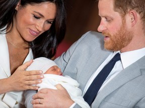 Prince Harry and Meghan, Duchess of Sussex hold their baby son, who was born on Monday morning, during a photocall in St George's Hall at Windsor Castle, in Berkshire, Britain May 8, 2019.