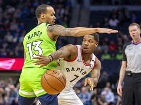 Raptors guard Kyle Lowry (7) passes the ball around Minnesota Timberwolves guard Shabazz Napier (13) in the first half at Target Center. Jesse Johnson-USA TODAY Sports