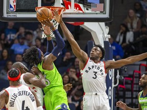Minnesota Timberwolves forward Robert Covington drives to the basket and shoots the ball over Toronto Raptors forward OG Anunoby in the first half at Target Center. Mandatory Credit: Jesse Johnson-USA TODAY Sports