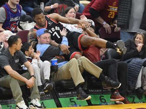 Raptors guard Kyle Lowry (7) falls in to the stands in the fourth quarter against the Cleveland Cavaliers at Rocket Mortgage FieldHouse. Mandatory Credit: David Richard-USA TODAY