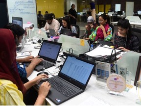 In this photograph taken on May 24, 2019, People work at their stations at the National Incubation Centre (NIC), a start-up incubator, in Lahore.