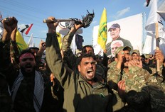 Members of the Hashed al-Shaabi paramilitary force chant anti-U.S. slogans during a protest over the killings of Iranian commander Qassem Soleimani and Iraqi paramilitary commander Abu Mahdi Al-Muhandis, on January 6, 2020 in Karrada in central Baghdad. (Photo by AHMAD AL-RUBAYE / AFP)
