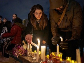 Mourners light candles for the victims of Ukrainian Airlines flight 752 which crashed in Iran during a vigil at Mel Lastman Square in Toronto on January 9, 2020. (Photo by GEOFF ROBINS/AFP via Getty Images)