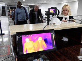 Travellers queue in front of a thermal scanner upon their arrival at the Murtala Mohammed International Airport in Lagos, Nigeria, on January 27, 2019.