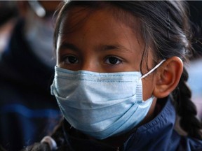 A Nepali student, wearing a face mask, attends a class at Matribhumi School in Bhaktapur, on the outskirts of Kathmandu on January 29, 2020, following the first SARS-like virus confirmed case in Nepal.