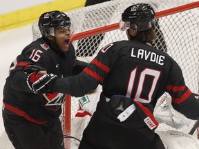 Canada's Akil Thomas, left, celebrates with teammate Raphael Lavoie, right, after scoring the eventual game-winning goal against Russia during the world junior hockey championship gold medal match, in Ostrava, Czech Republic, Sunday, Jan. 5, 2020.