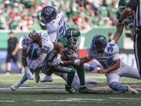 Argonauts wide receiver Alex Charette (11), defensive back Matt Webster (20) and kicker Drew Brown collide with Roughriders wide receiver Christion Jones during first half CFL action in Regina on July 1, 2019.