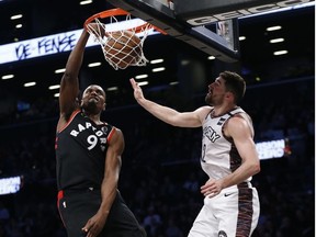 Toronto Raptors center Serge Ibaka scores against Brooklyn Nets forward Joe Harris in the second quarter at Barclays Center.