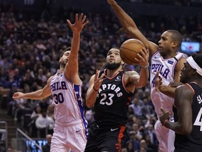 Philadelphia 76ers guard Furkan Korkmaz and forward Al Horford  try to block a shot attempt by Toronto Raptors guard Fred VanVleet  during the first half at Scotiabank Arena.  VanVleet had a game-high 22 points in the Raptors' win.  (John E. Sokolowski/USA Today Sports)