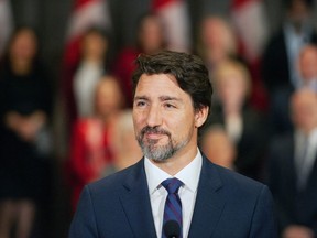 Prime Minister Justin Trudeau stands in front of his cabinet as he speaks to media during the final day of the Liberal cabinet retreat at the Fairmont Hotel in Winnipeg, Tuesday, Jan. 21, 2020.