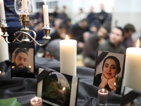 Photographs of student victims of a Ukrainian passenger jet which crashed in Iran are seen during a vigil at University of Toronto student housing in Toronto January 8, 2020.  REUTERS/Chris Helgren
