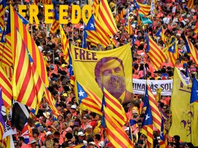 In this file photo taken on Sept. 11, 2018, demonstrators hold a banner demanding freedom for jailed Catalan leader Oriol Junqueras as they gather to take part in a pro-independence demonstration in Barcelona, marking the National Day of Catalonia, the "Diada".