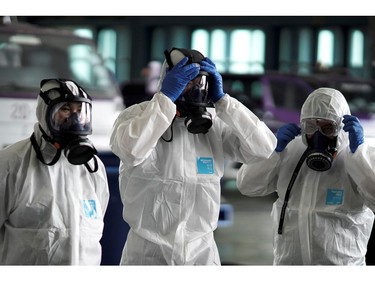 FILE PHOTO: Members of the Thai Airways crew prepare themselves before disinfecting the cabin of an aircraft of the national carrier during a procedure to prevent the spread of the coronavirus at Bangkok's Suvarnabhumi International Airport, Thailand, January 28. REUTERS/Athit Perawongmetha/File Photo ORG XMIT: FW1