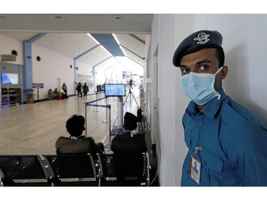 A security official wears a mask as he stands guard near a thermal scanner at Bandaranaike International Airport after Sri Lanka confirmed the first case of coronavirus in the country, in Katunayake, Sri Lanka January 30, 2020. REUTERS/Dinuka Liyanawatte ORG XMIT: GGGCOL11