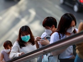 People wear masks to prevent the spread of the new coronavirus in Bangkok, Thailand Jan. 28, 2020.