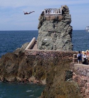 A cliff diver performs for tourists along Mazatlan’s malecon.